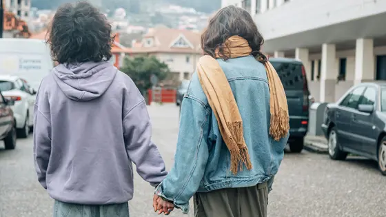 A couple holding hands on the road