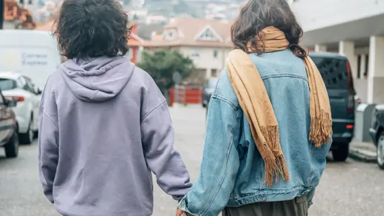 A couple holding hands on the road