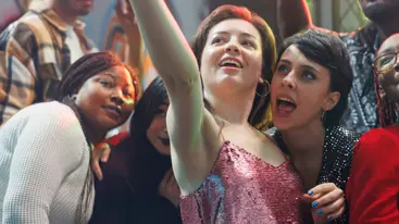 A photo group of young adults standing together and posing for a selfie.