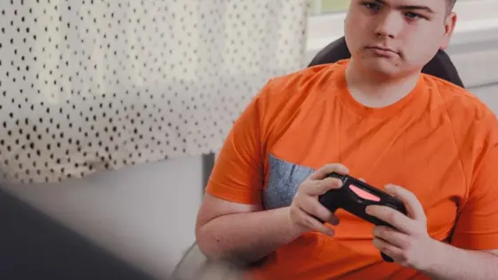 Photograph of a young person playing video games.