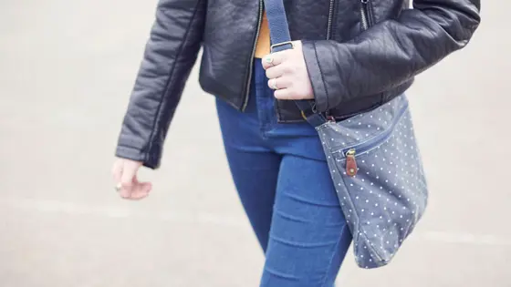 Teenage girl walking down the street.