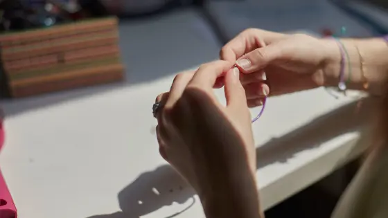 Hands holding a bracelet