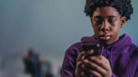 Teenage boy looking at his phone