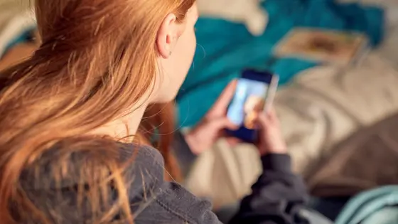 Photograph of a girl using her phone.