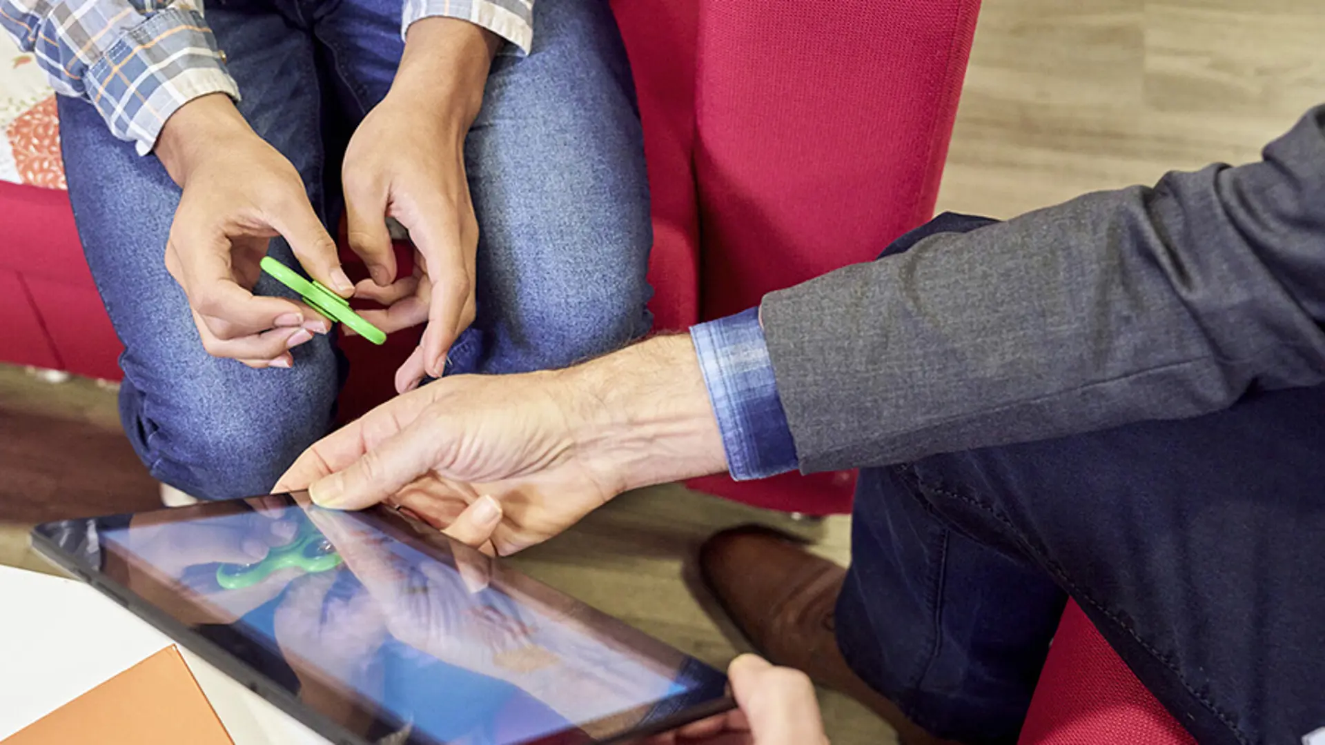 Two adults' looking at information on a tablet