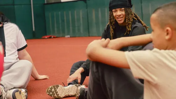 A group of teenagers sat down inside a basketball court