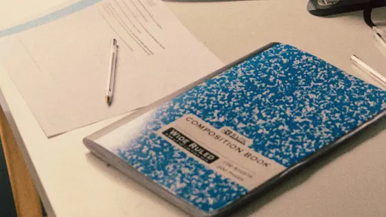 Photo of a closed notepad on a desk.