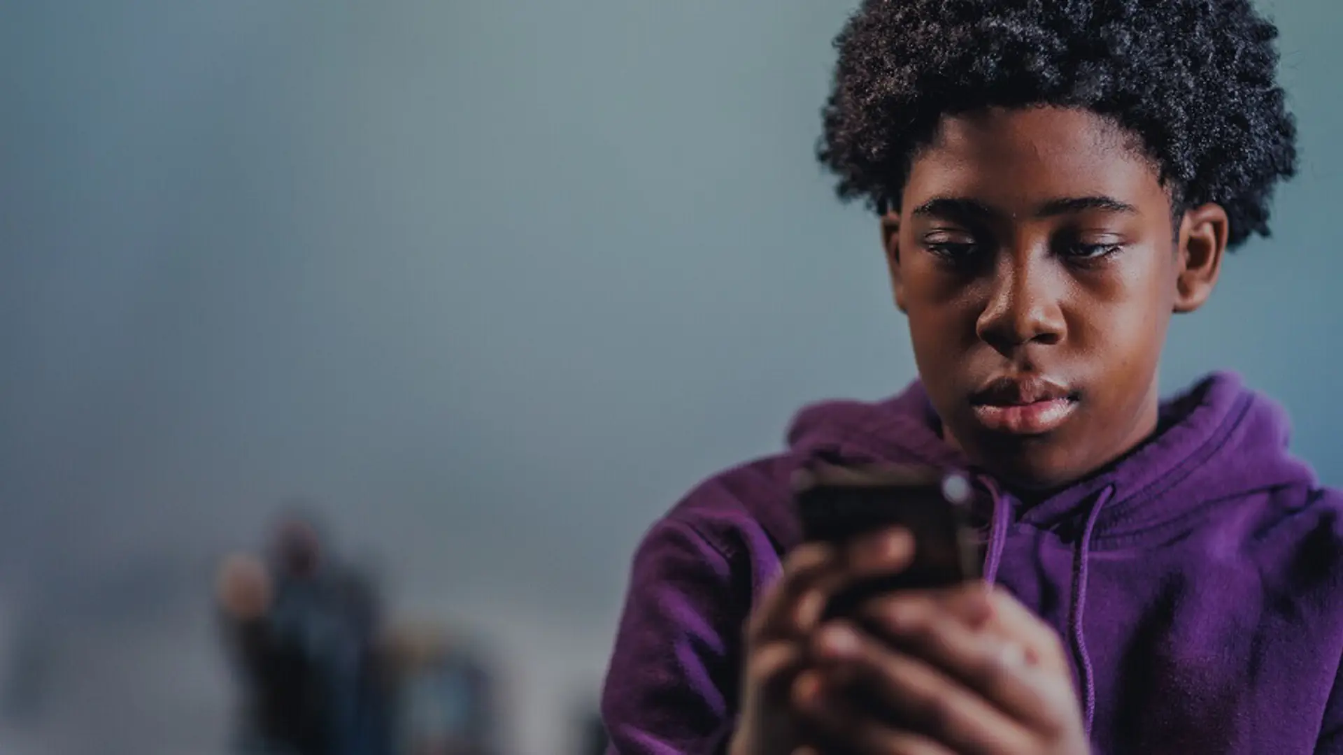 Teenage boy looking at his phone