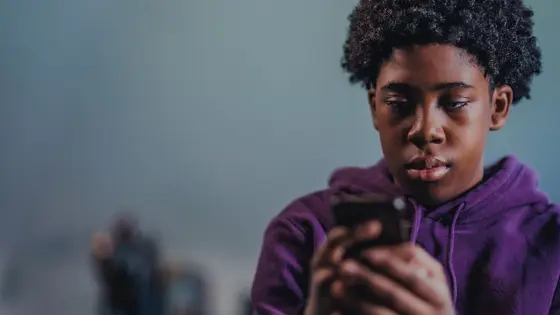 Teenage boy looking at his phone