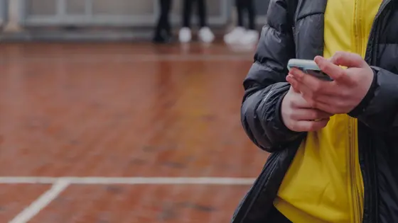 A young person holding a phone