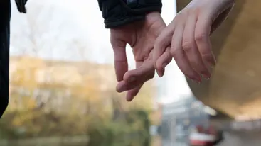 Two young people holding hands