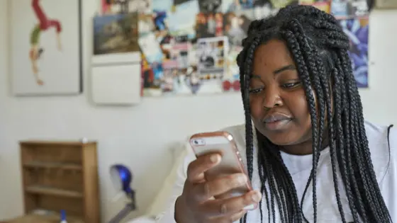 Young person looking at a phone