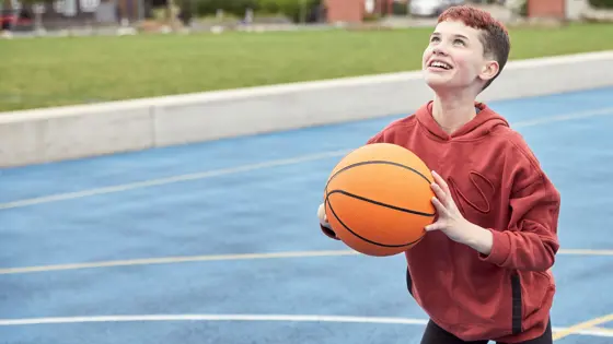 Photo of a young person playing basketball.
