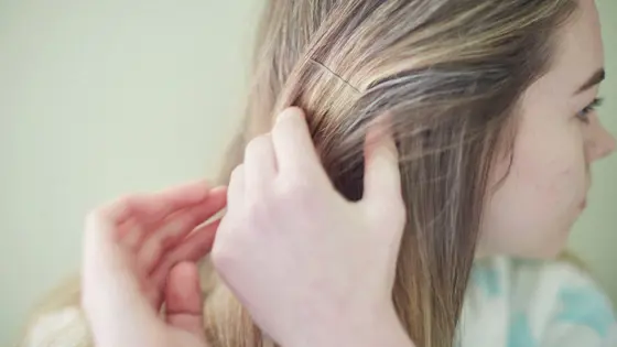 Teenage girl playing with her hair.